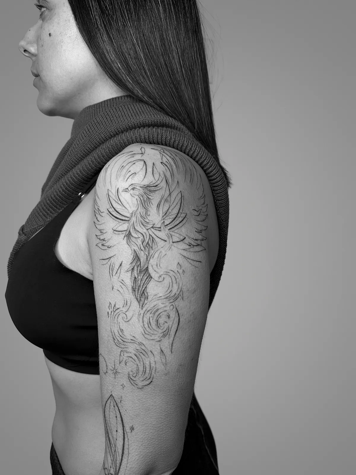 Phoenix tattoo with ornamental flame and foliage details