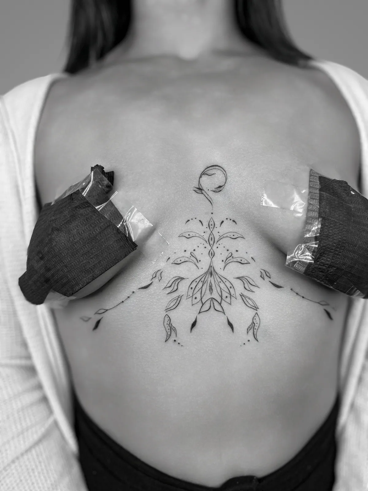 Original ornamental linework following the contours of the sternum