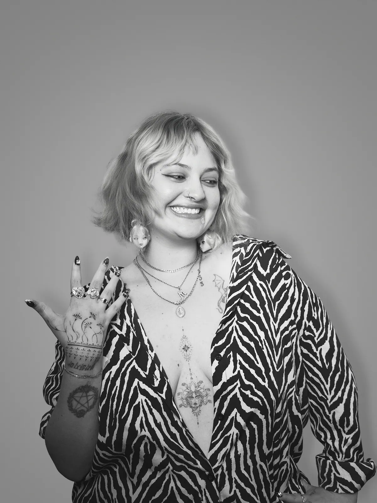 Studio portrait of a woman wearing her tattoos, photograph 7 of 16