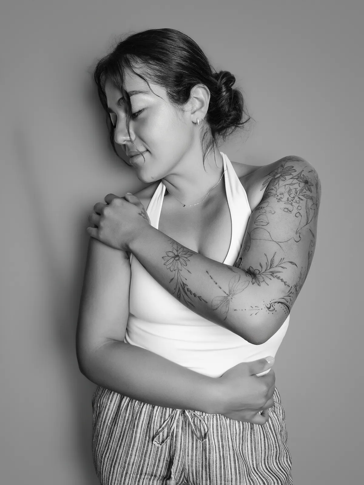 Studio portrait of a woman wearing her tattoos, photograph 15 of 16